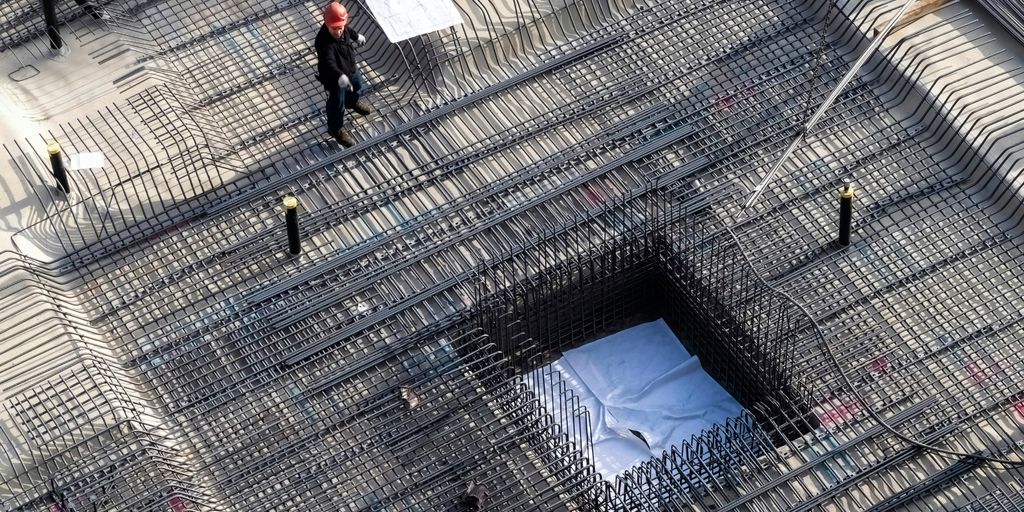 man in black jacket walking on sidewalk during daytime