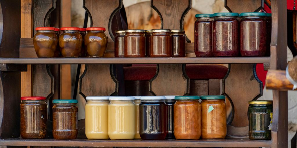 a shelf with many jars of food on it
