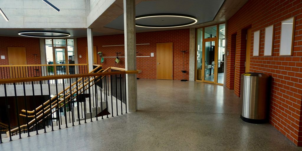 brown wooden door near white concrete staircase