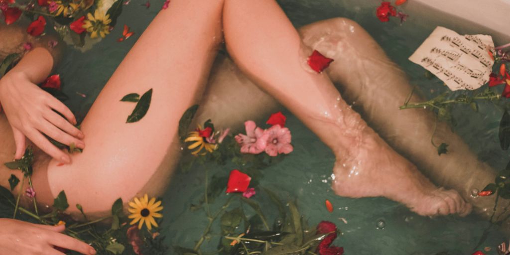bathtub with water and flowers