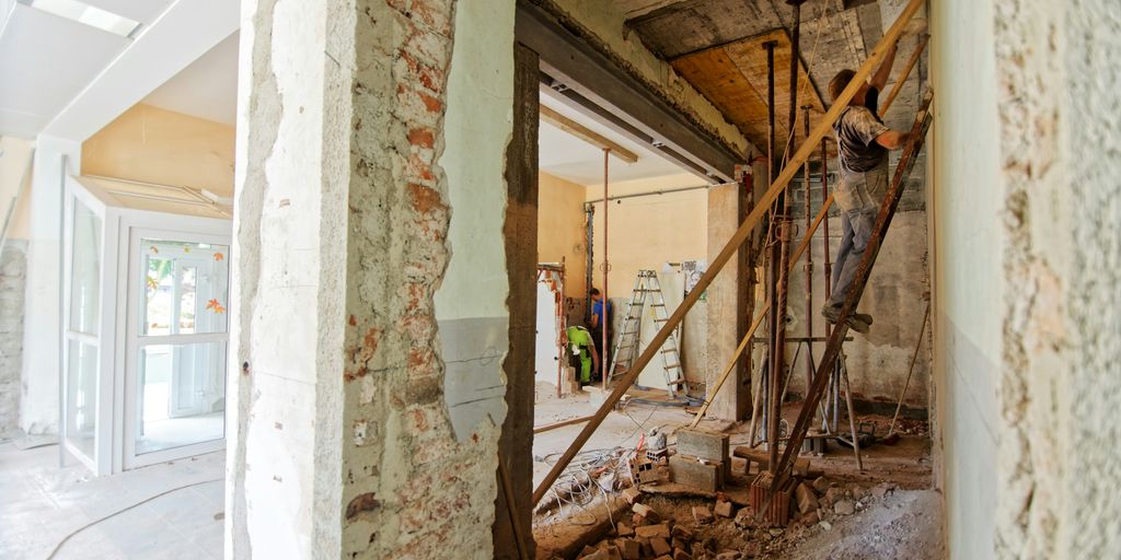 man climbing on ladder inside room