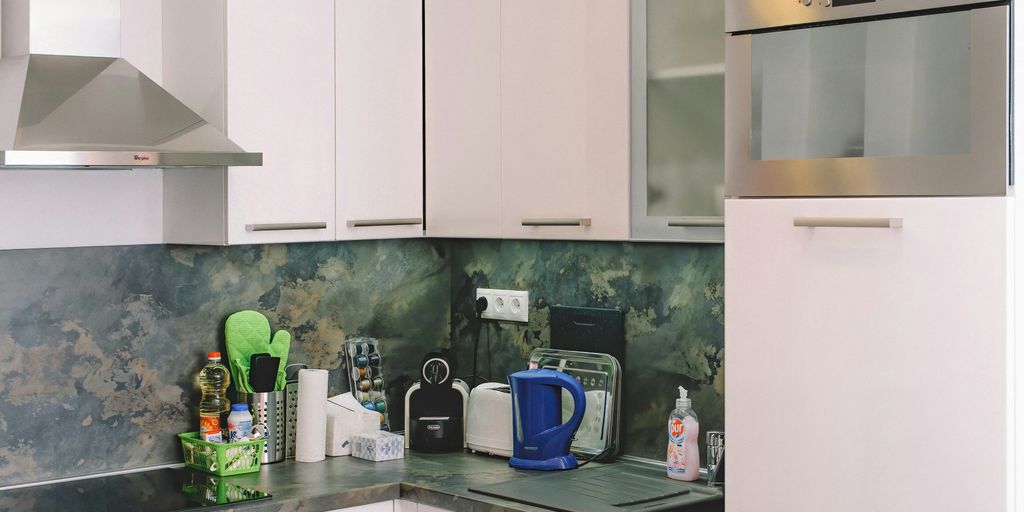white wooden kitchen cabinet with blue and white electric kettle