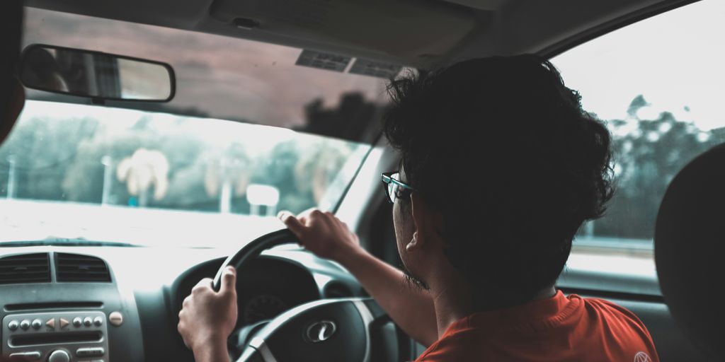 man driving car