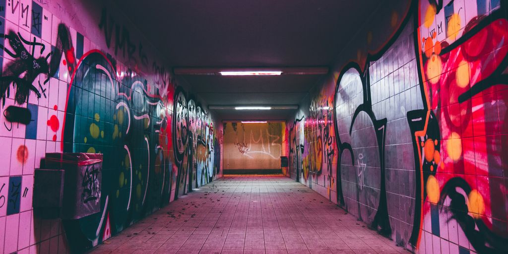 empty tunnel pathway with graffiti walls