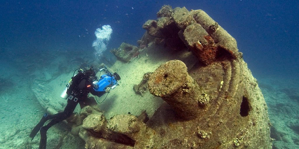 person scuba driving underwater