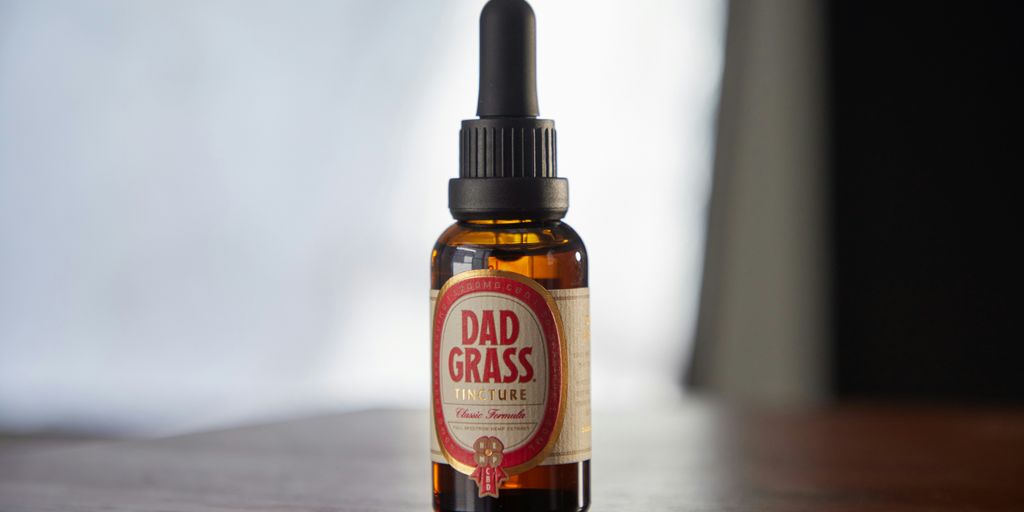 a bottle of dad grass sitting on a table