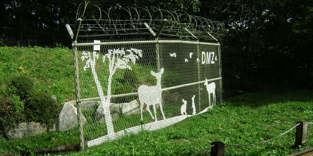 a fence with a picture of animals on it