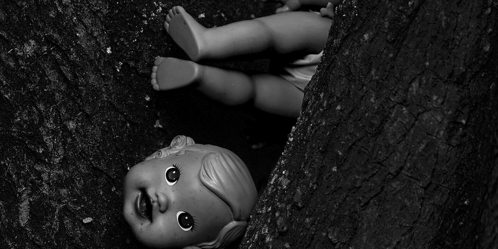 a doll is laying down in a tree