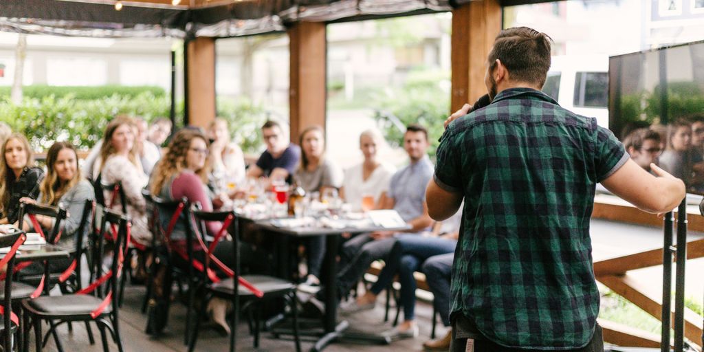 man standing infront of group of people