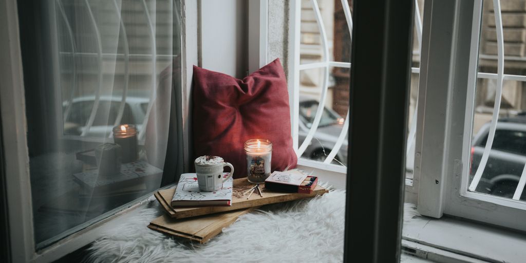 photo of gel candle on board beside pillow