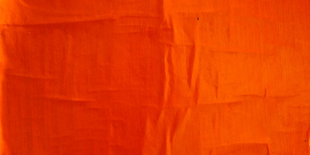 orange textile on white textile