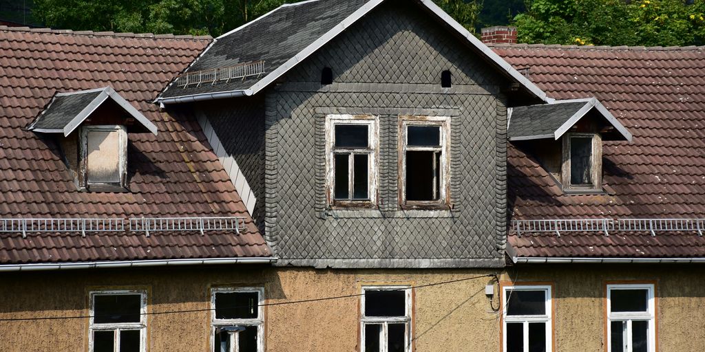 a house with a clock on the front of it