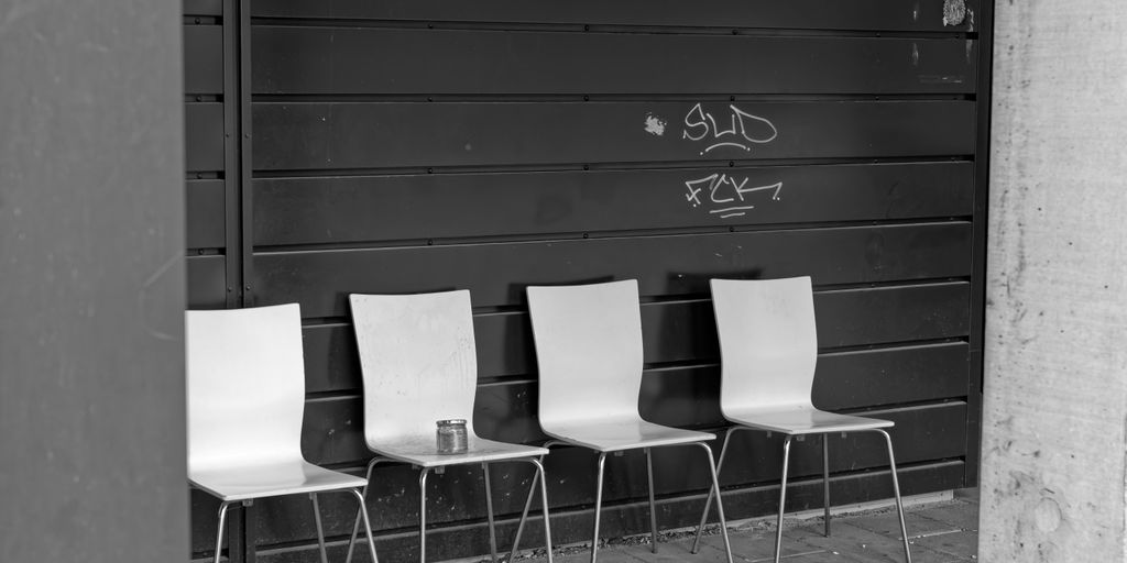 a group of chairs in front of a black door