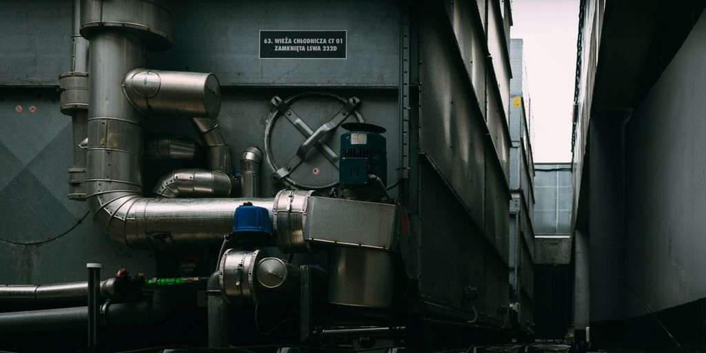 a large metal pipe next to a building