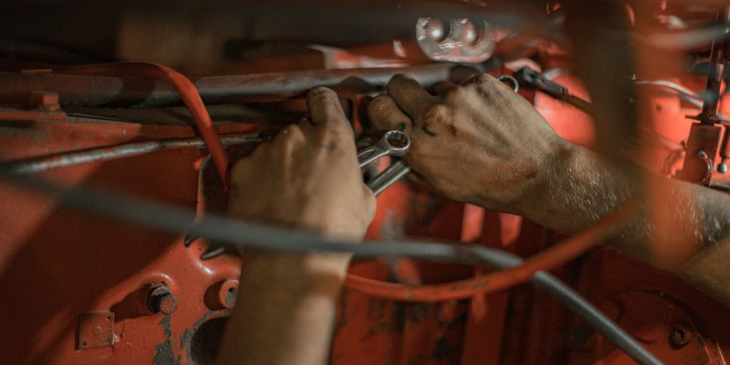 person holding red metal frame